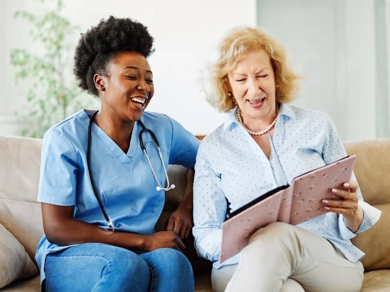 senior housing planning services discussion between caregiver and older adult reviewing care options at home