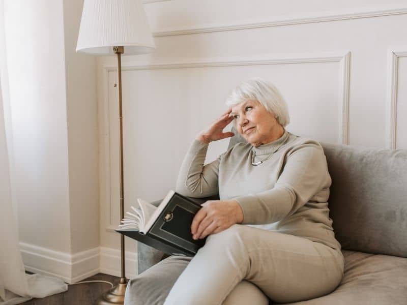 older adult thoughtfully reviewing options with personalized senior housing guidance at home