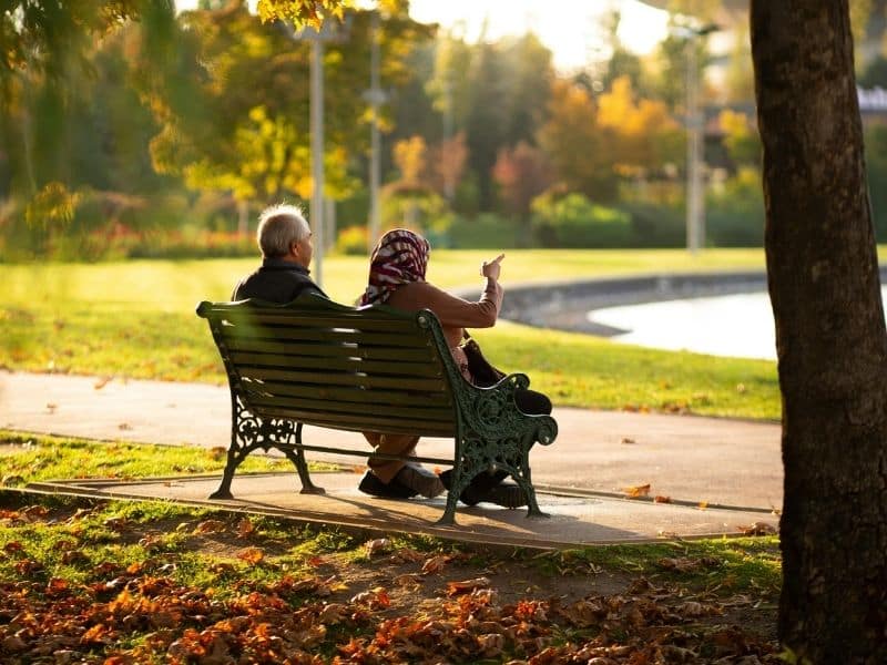 family-focused senior living services supporting older adults enjoying time together in peaceful outdoor setting
